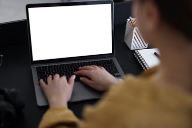 Photo of Woman watching webinar at table in office, closeup