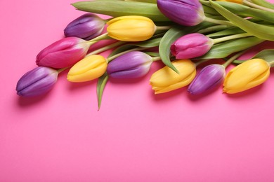 Photo of Beautiful tulips on pink background, flat lay. Space for text