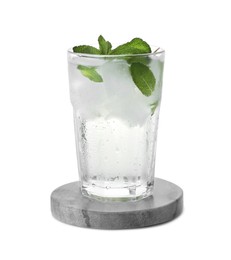 Photo of Glass of refreshing drink with mint and stylish stone cup coaster isolated on white