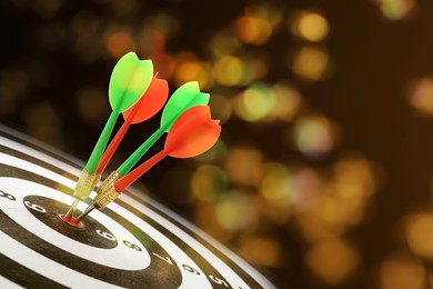 Image of Darts hitting target on board against blurred background