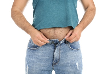 Photo of Overweight man in small pants on white background, closeup view