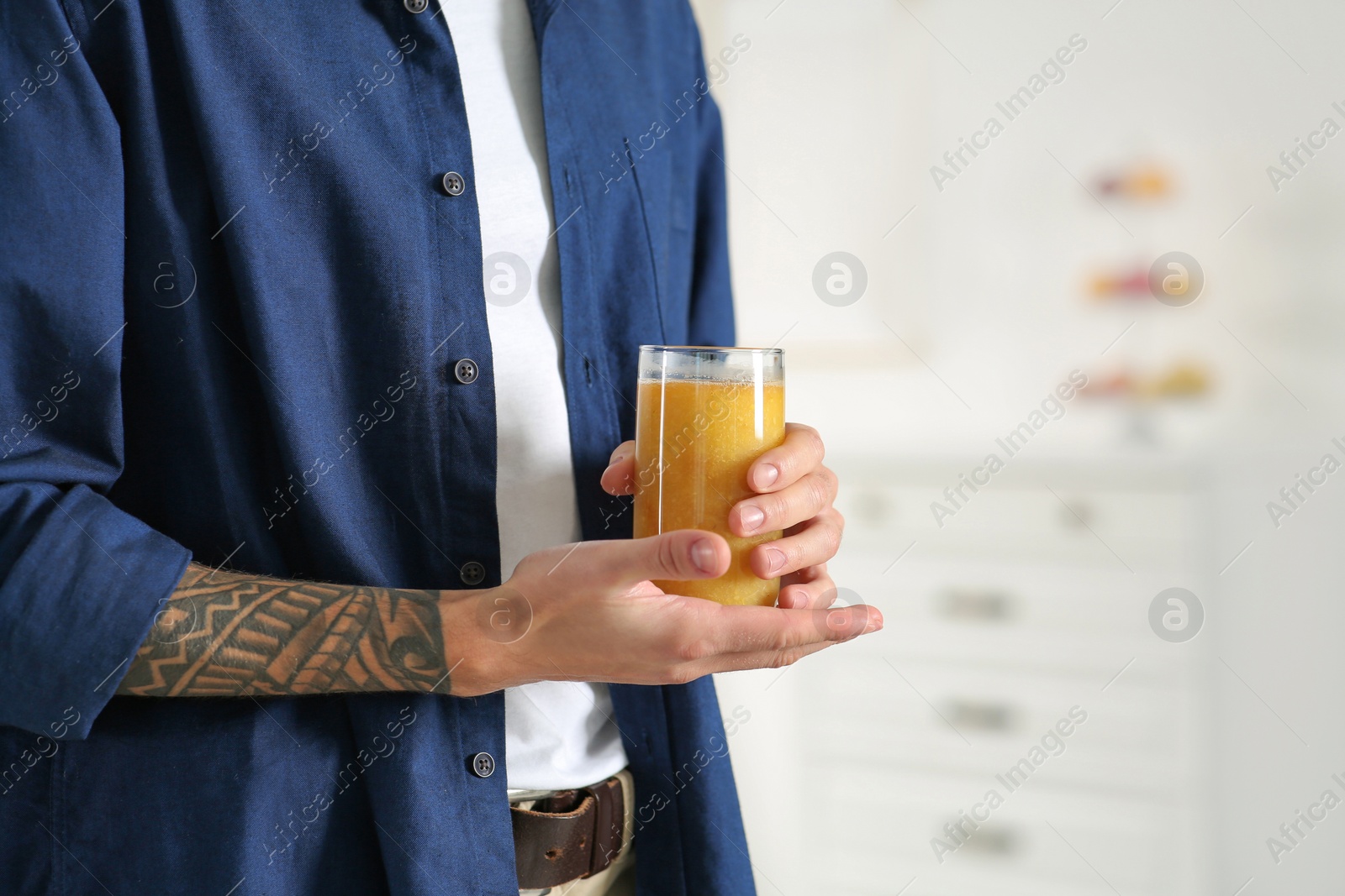 Photo of Man with delicious smoothie at home, closeup. Space for text