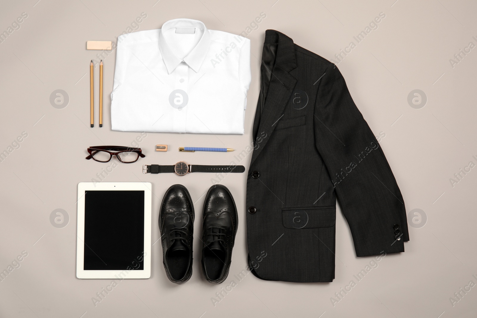 Photo of School uniform for boy and tablet on grey background, top view