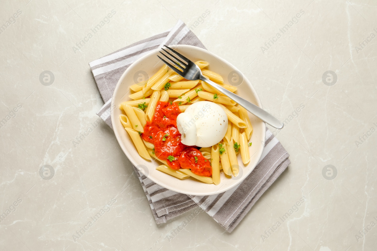 Photo of Delicious pasta with burrata cheese and sauce on light grey table, top view