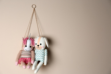 Photo of Shelf with cute toys on beige wall, space for text. Child's room interior element