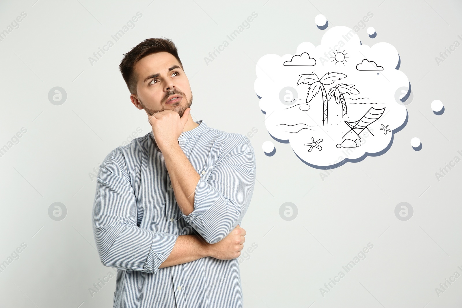 Image of Young man dreaming about vacation on light background