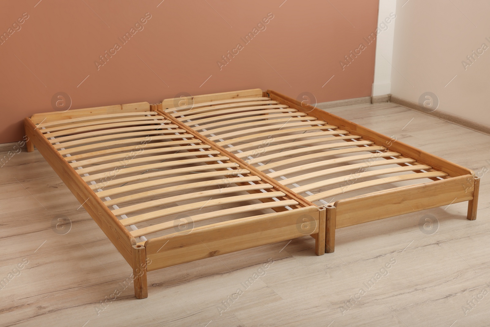 Photo of Wooden bed frame on floor in room