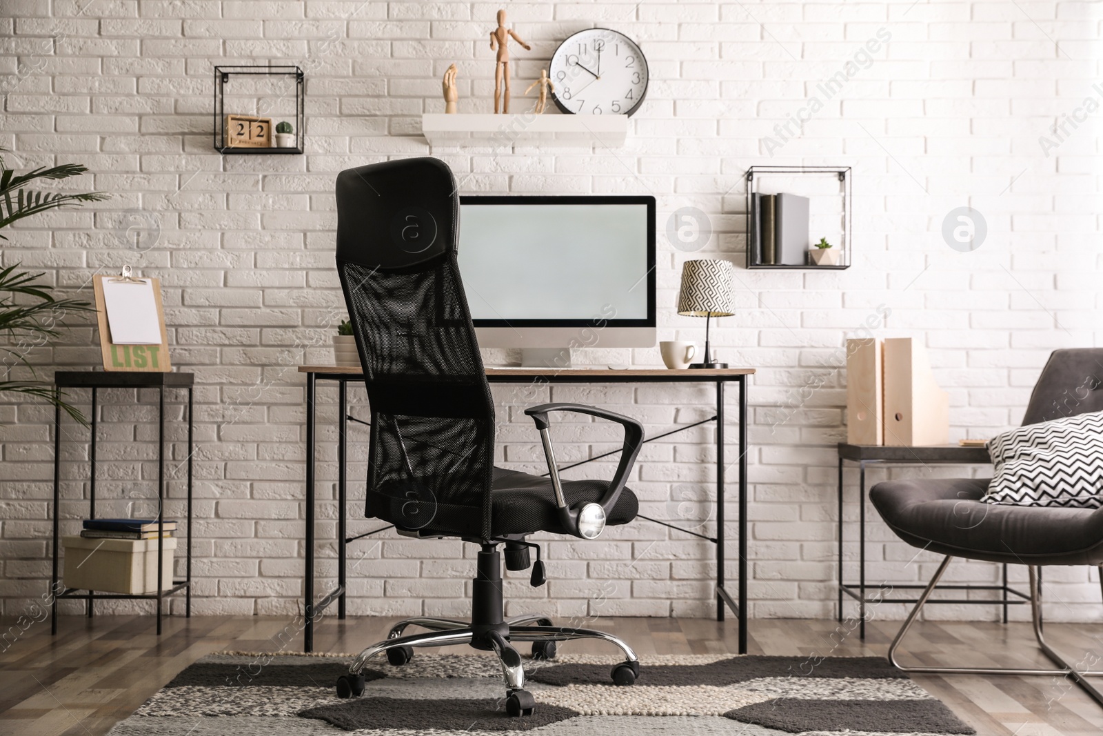 Photo of Comfortable chair near desk in modern office interior