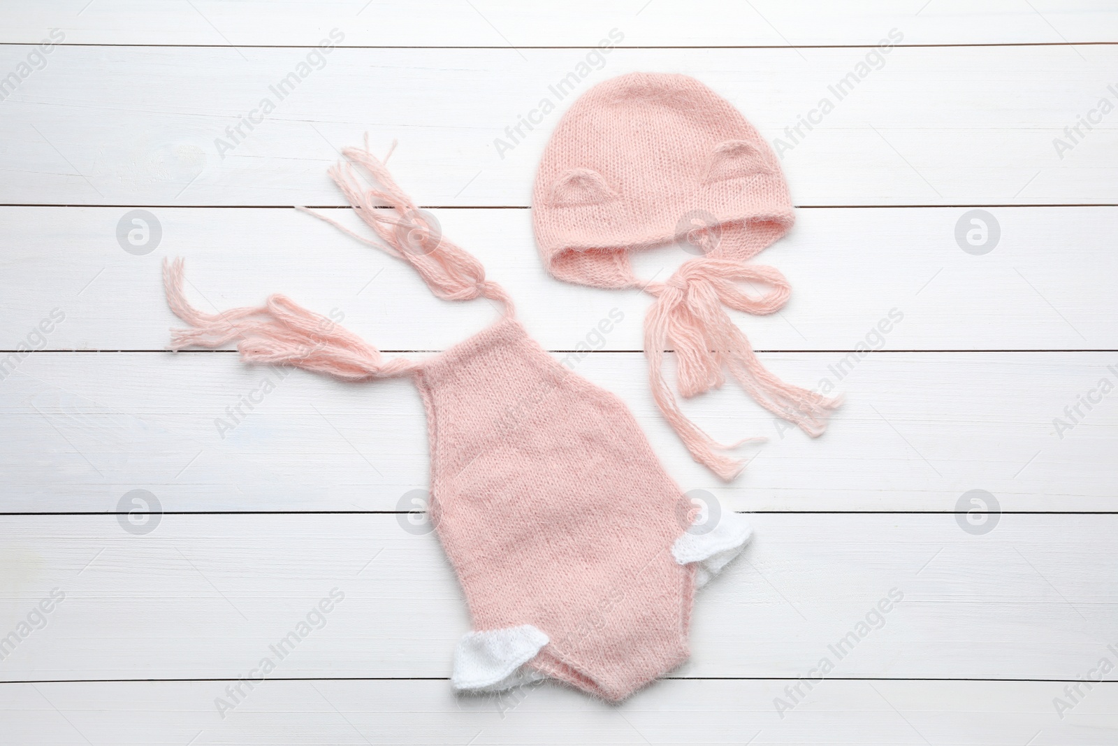 Photo of Stylish child's clothes on white wooden table, flat lay