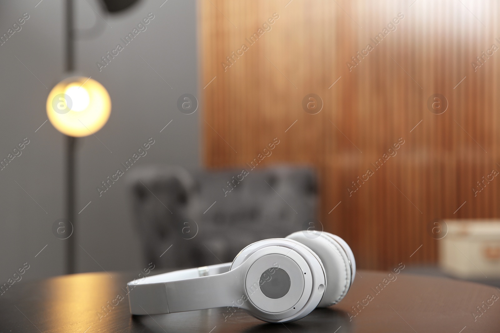 Photo of Stylish headphones on table indoors. Space for text