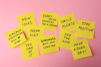 Photo of Paper notes with life-affirming phrases on pink background