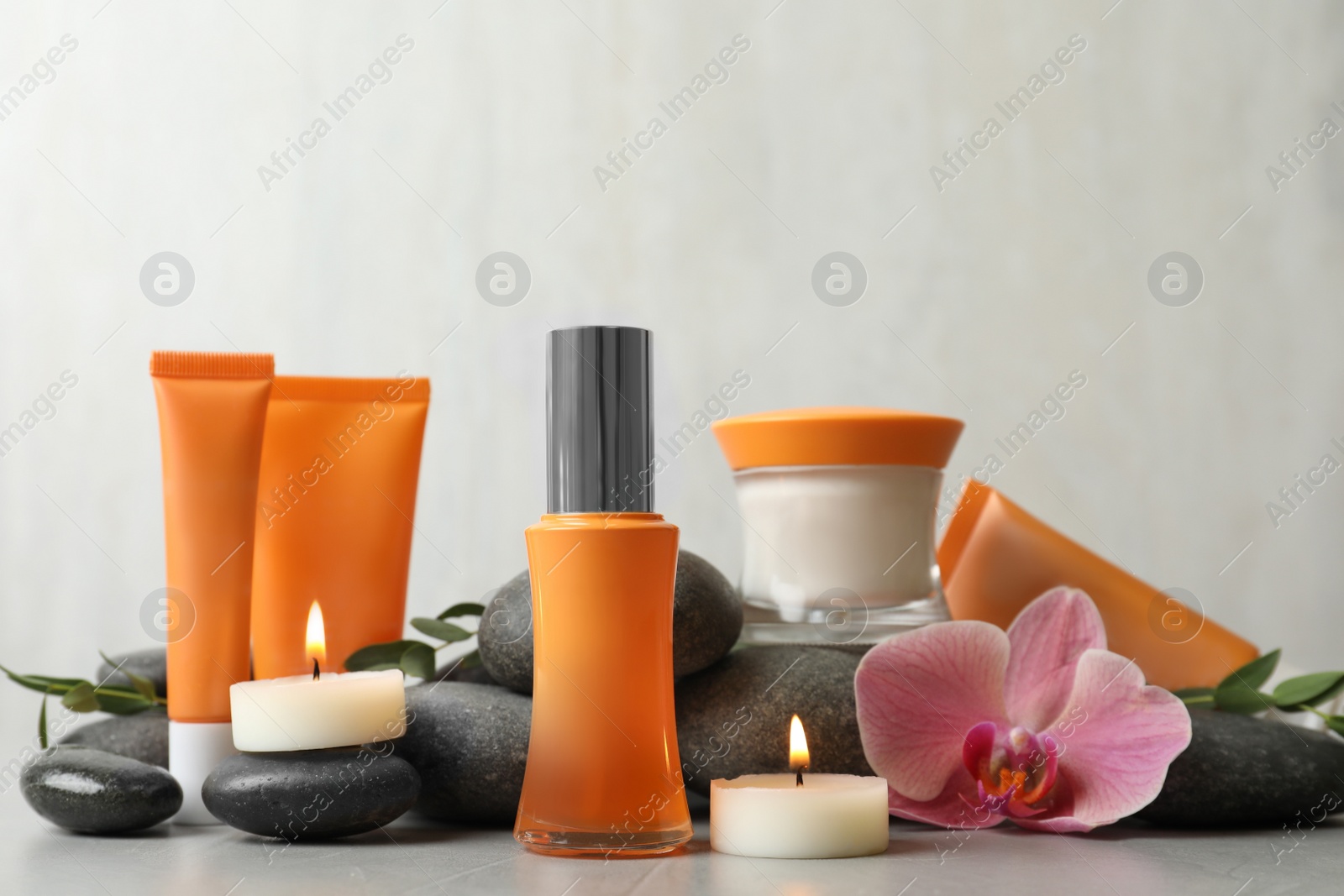 Photo of Composition with cosmetic products on light grey stone table