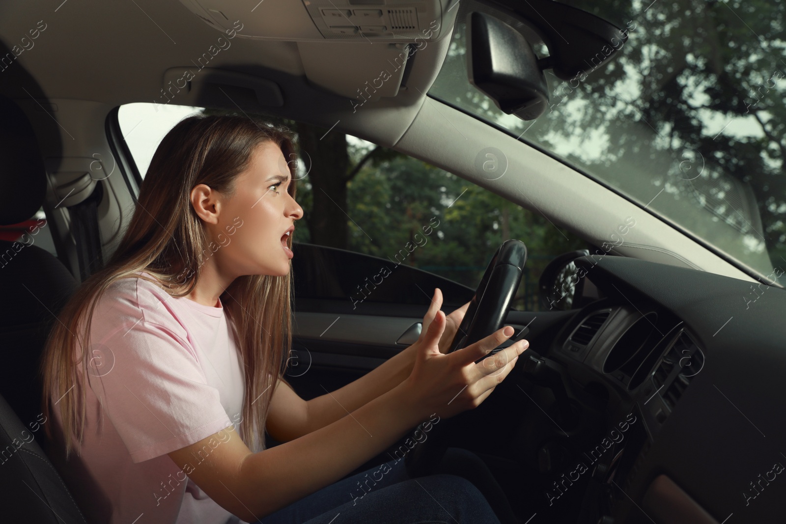 Photo of Stressed young woman in driver's seat of modern car