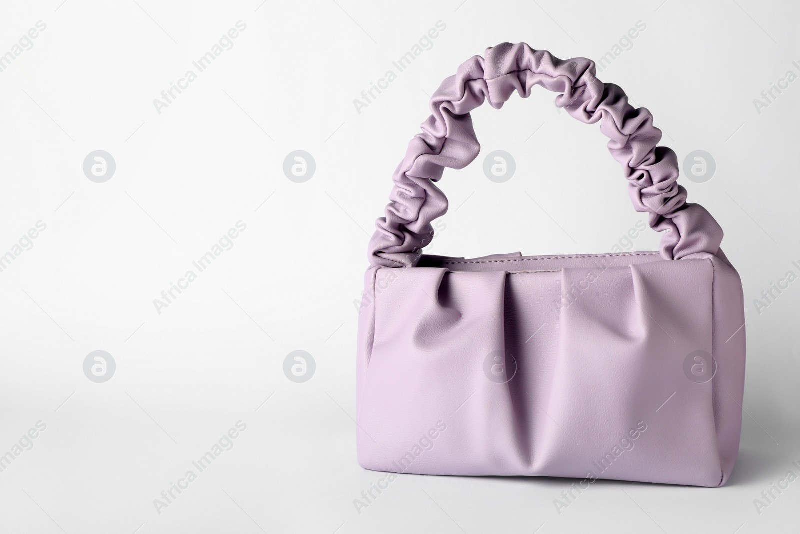 Photo of Stylish woman's bag on light background. Space for text