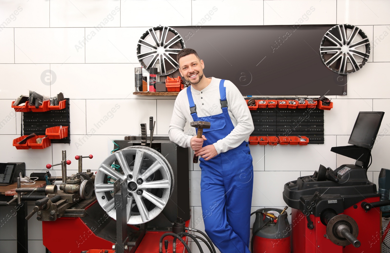 Photo of Mechanic near car disk lathe machine at tire service