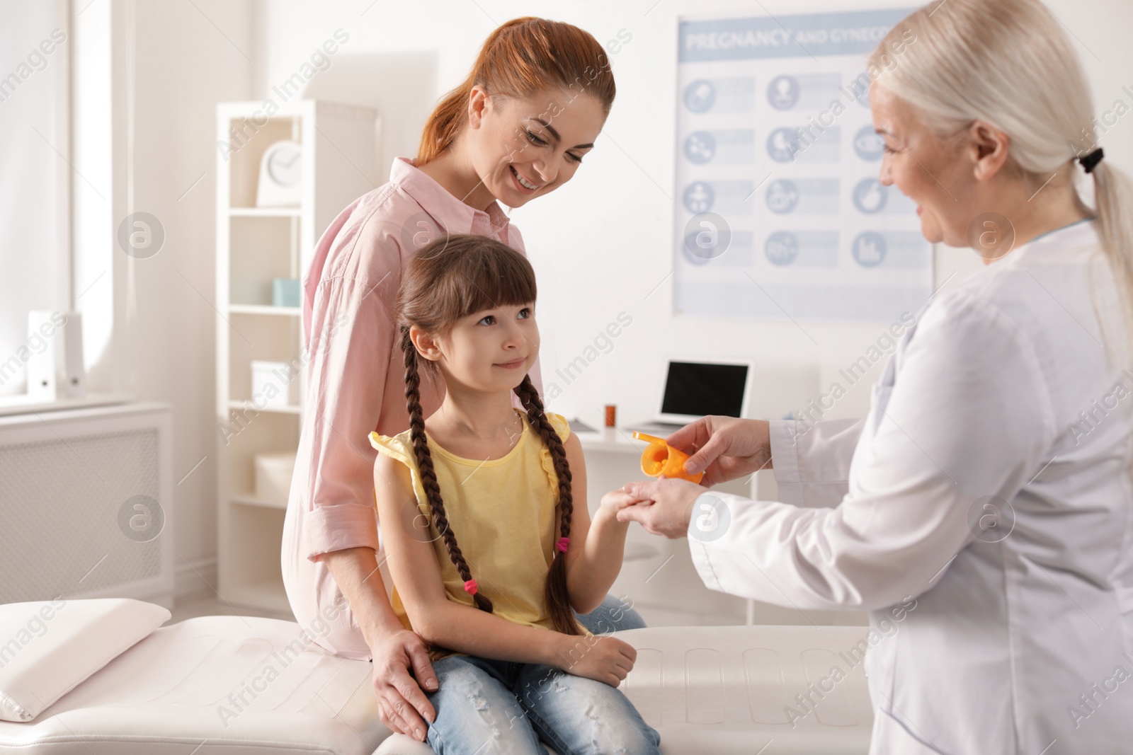 Photo of Mother with child visiting doctor in hospital