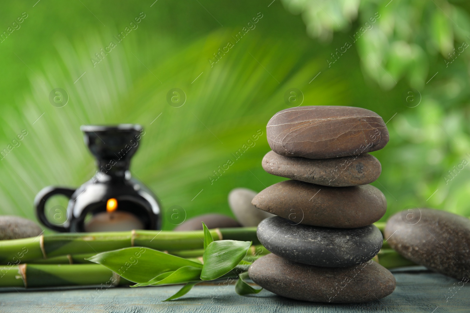 Photo of Composition with stones on table against blurred background. Zen concept