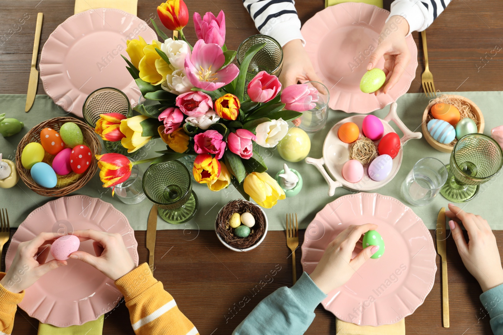 Photo of Festive table setting. Women celebrating Easter at home, top view