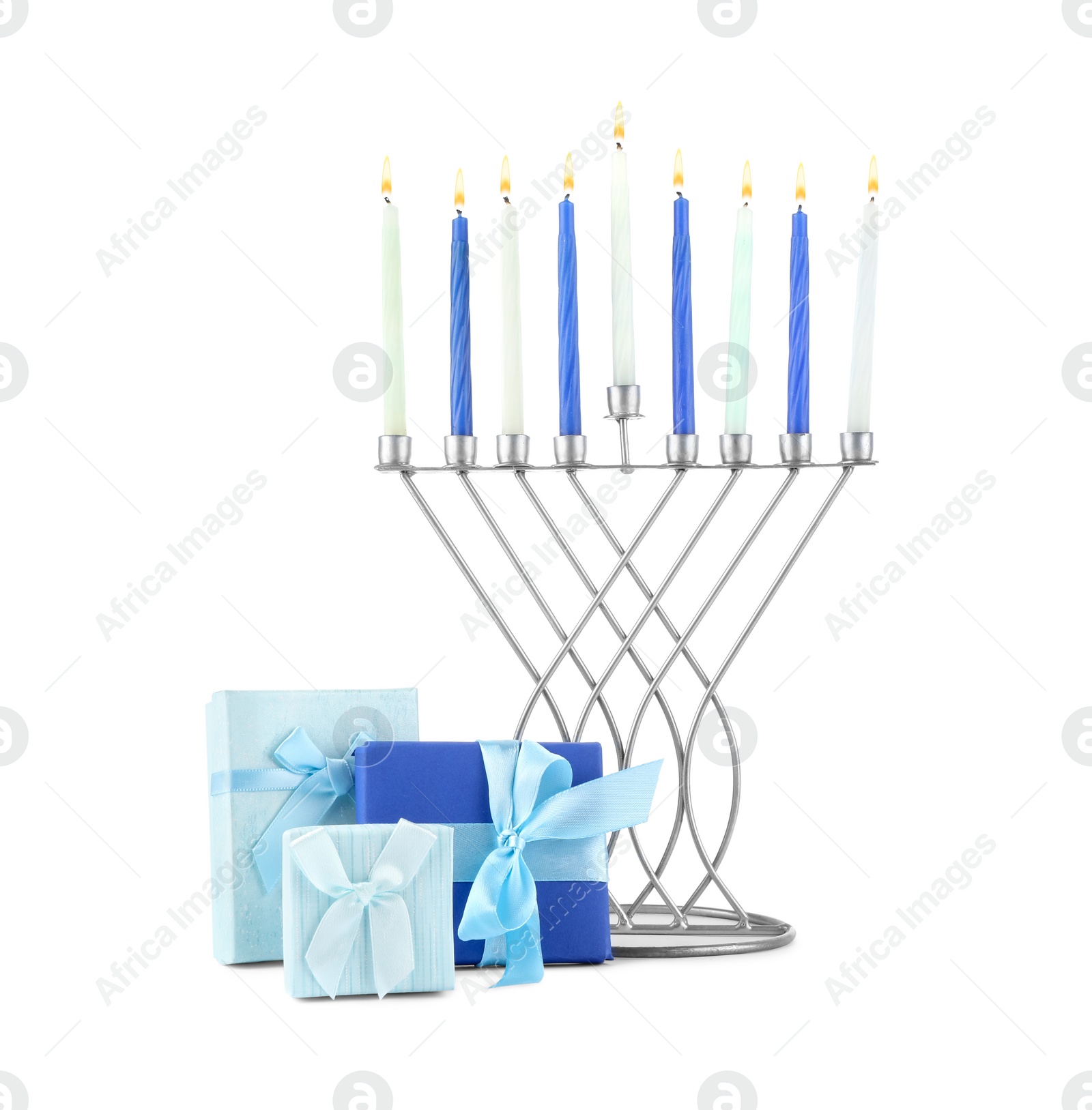 Photo of Hanukkah celebration. Menorah with candles and gift boxes isolated on white