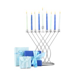 Photo of Hanukkah celebration. Menorah with candles and gift boxes isolated on white