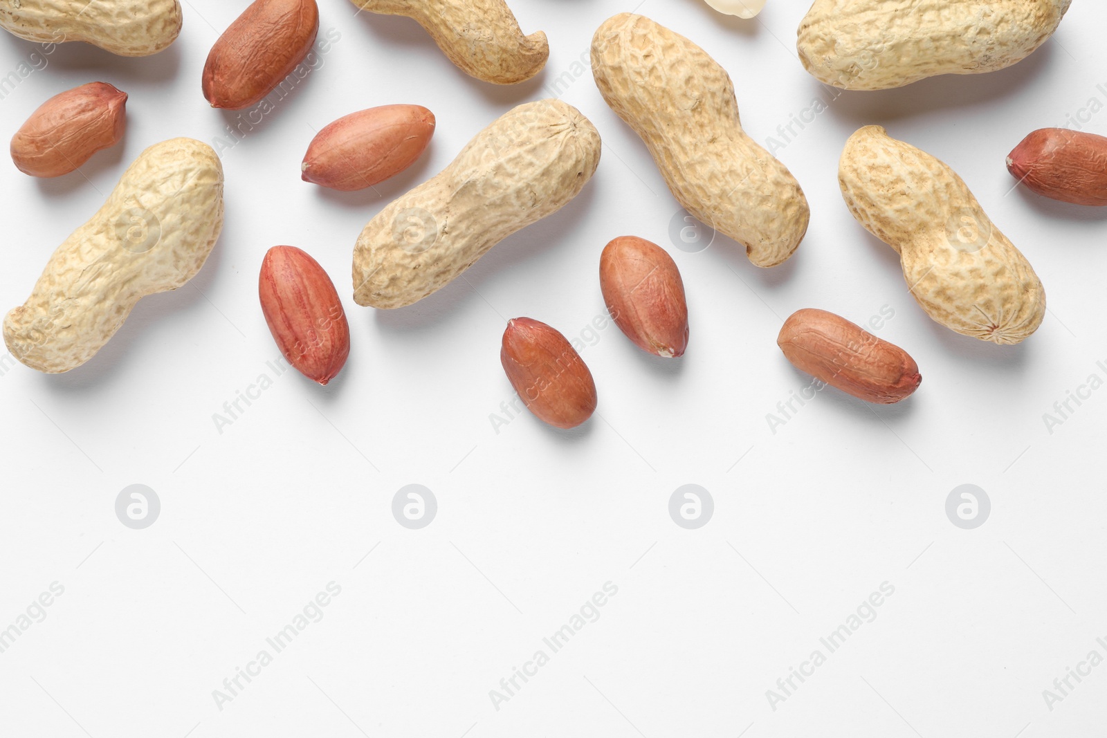 Photo of Fresh peanuts on white background, flat lay