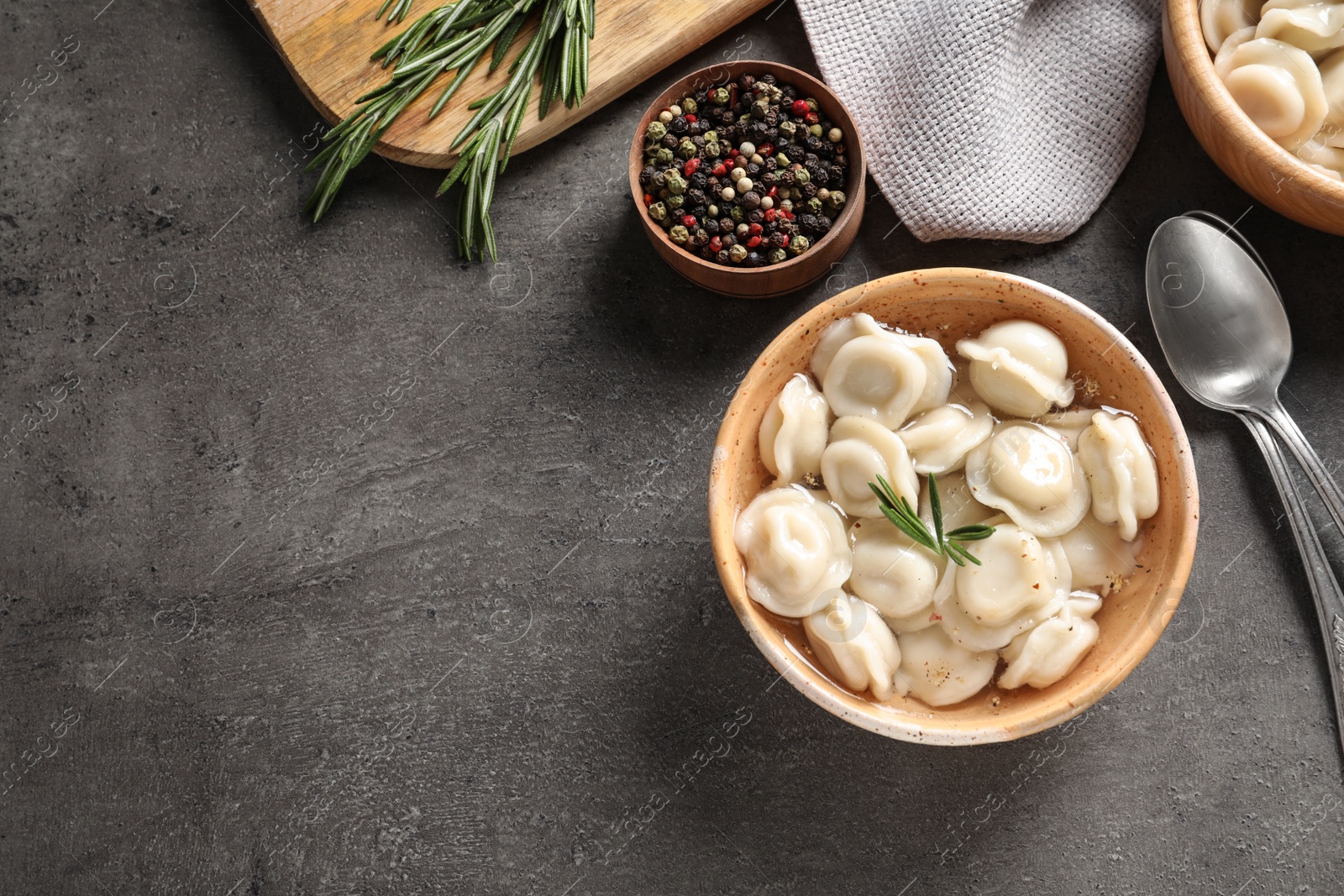 Photo of Bowl of tasty dumplings served on table, top view. Space for text