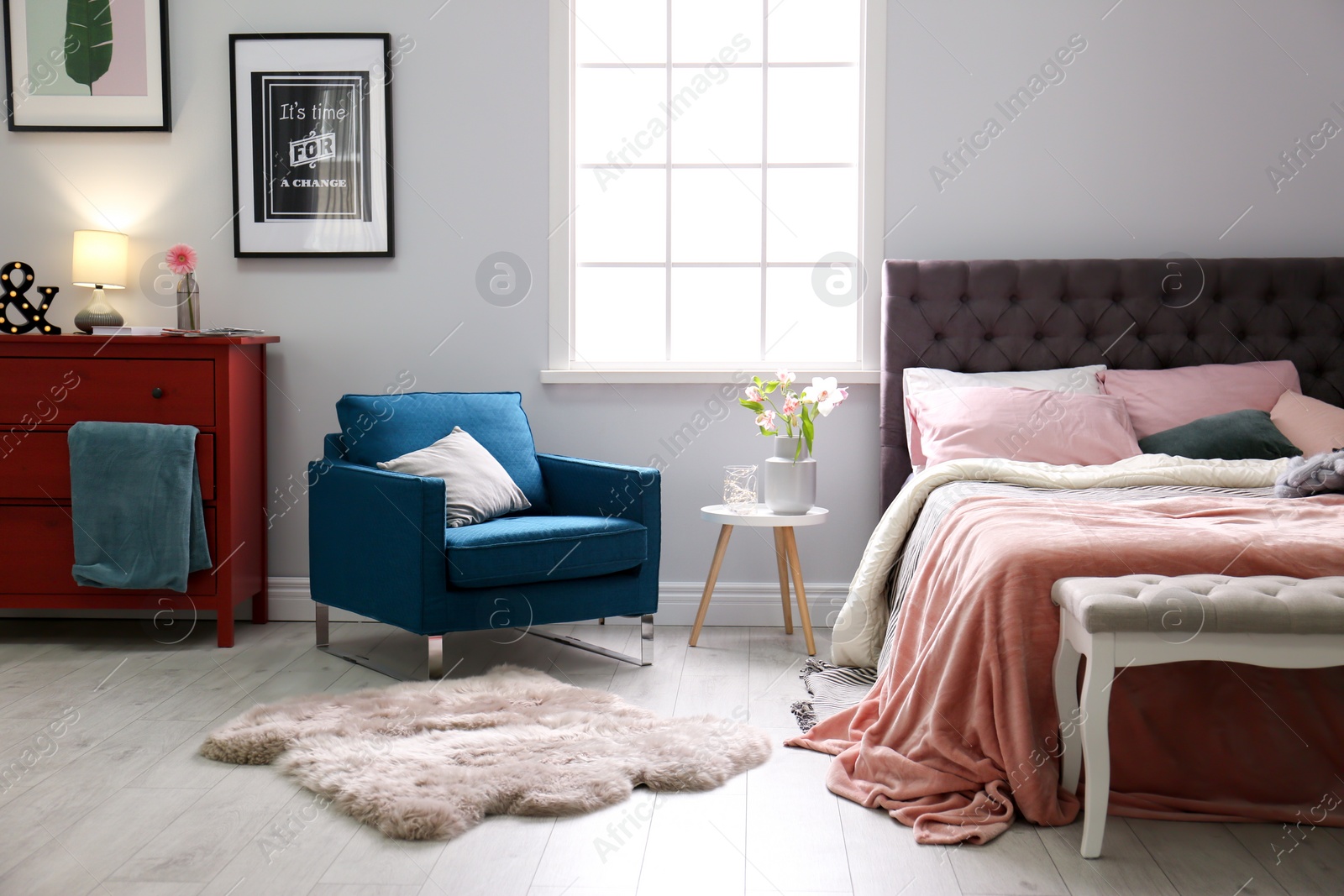 Photo of Interior of light modern room with comfortable bed