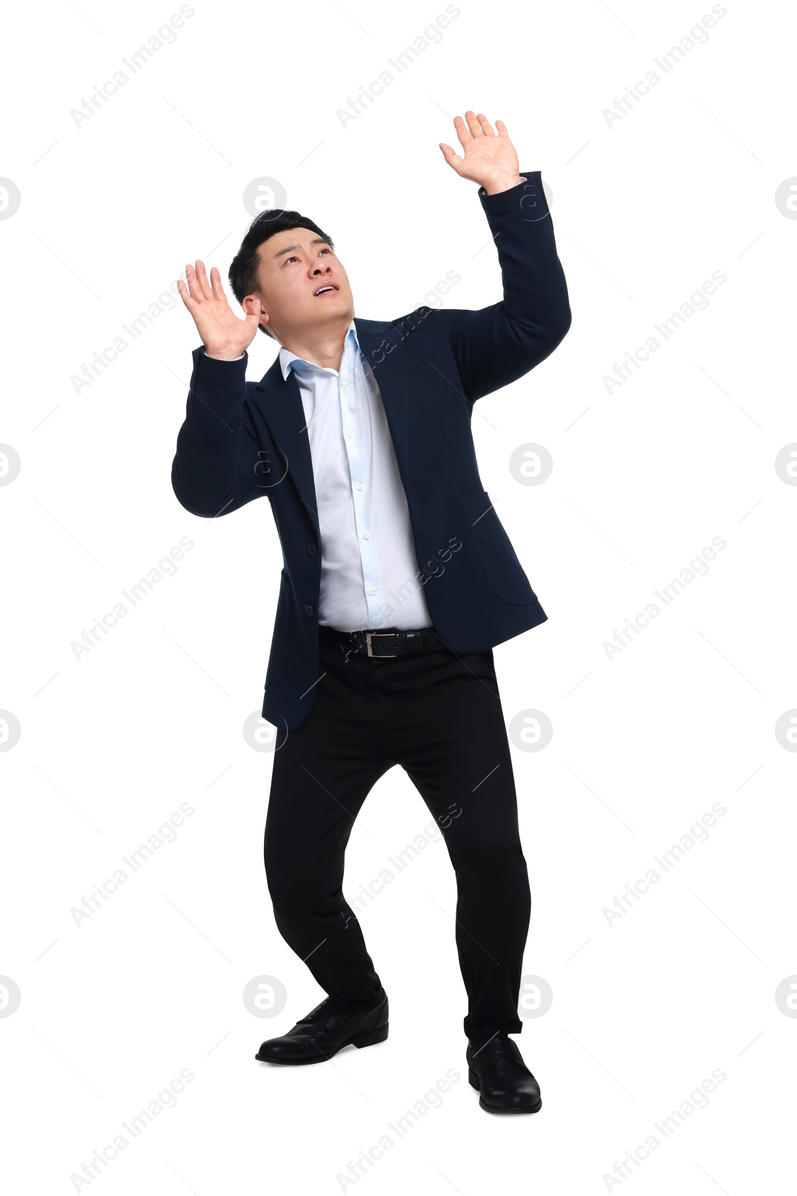 Photo of Scared businessman in suit posing on white background