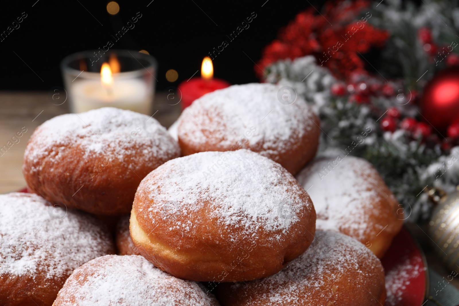 Photo of Delicious sweet buns with powdered sugar on table, closeup