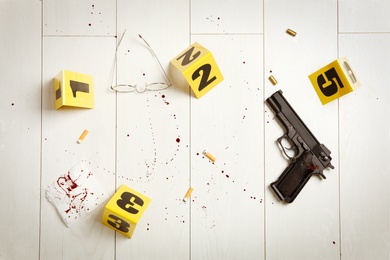 Flat lay composition with evidences on white wooden background. Crime scene