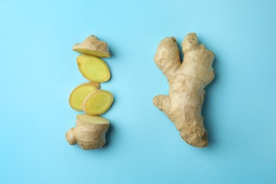 Fresh ginger on pale light blue background, flat lay