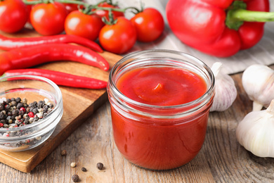 Photo of Delicious fresh tomato sauce on wooden table, closeup