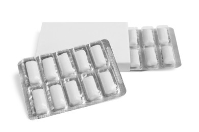 Photo of Pack and blisters with tasty chewing gums isolated on white