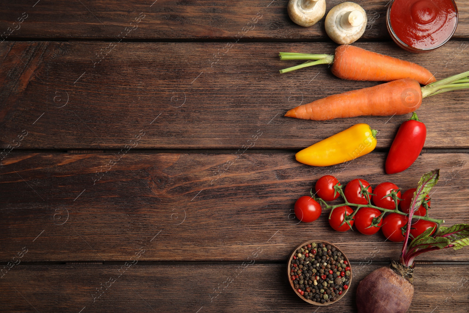 Photo of Flat lay composition with ingredients for cooking on wooden table. Space for text