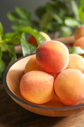 Plate with fresh sweet ripe peaches on table