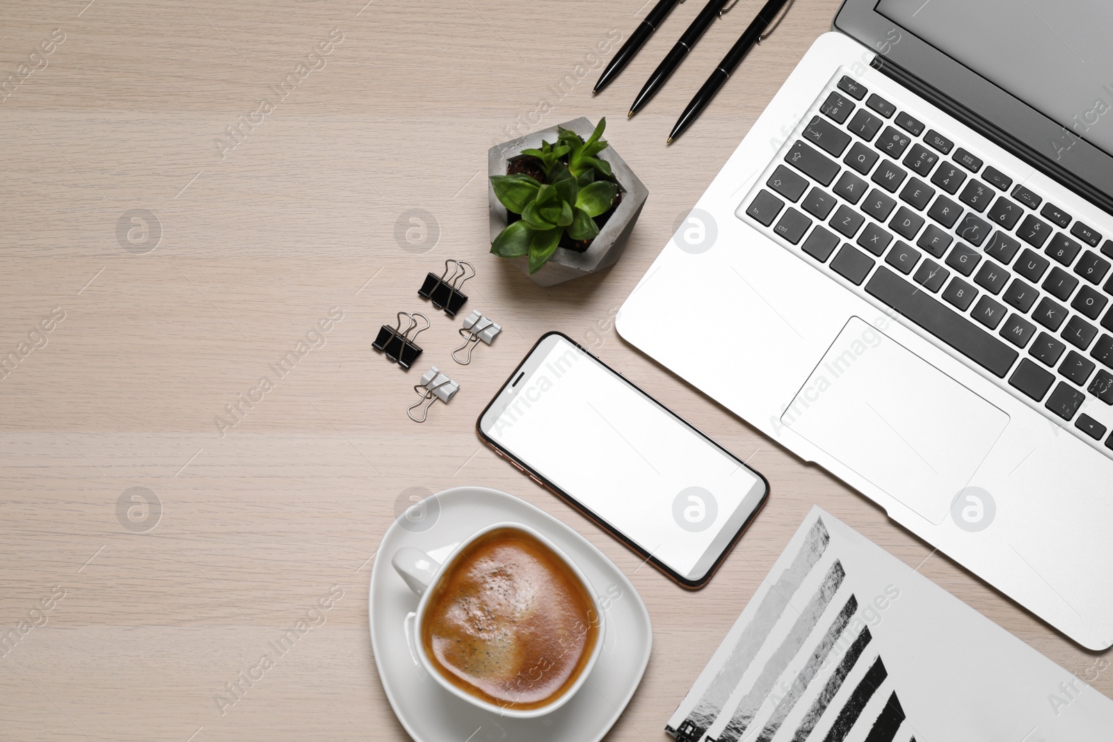 Photo of Flat lay composition of smartphone with blank screen and laptop on wooden table, space for text