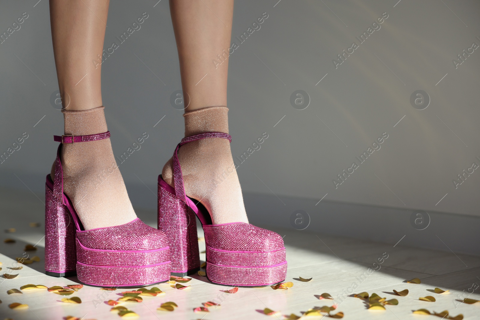 Photo of Stylish party. Woman wearing pink high heeled shoes with platform and square toes indoors, closeup. Space for text