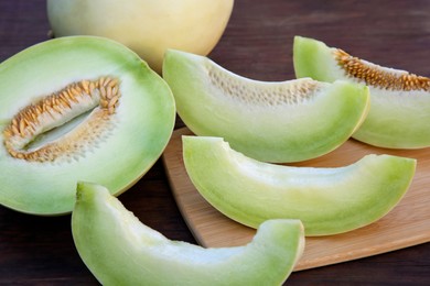 Cut tasty ripe melon on wooden table