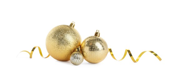 Photo of Beautiful shiny golden Christmas balls on white background