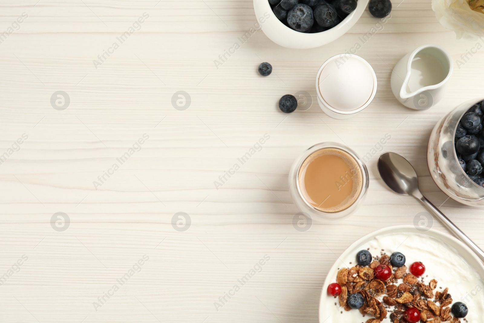 Photo of Delicious breakfast served on white wooden table, flat lay. Space for text