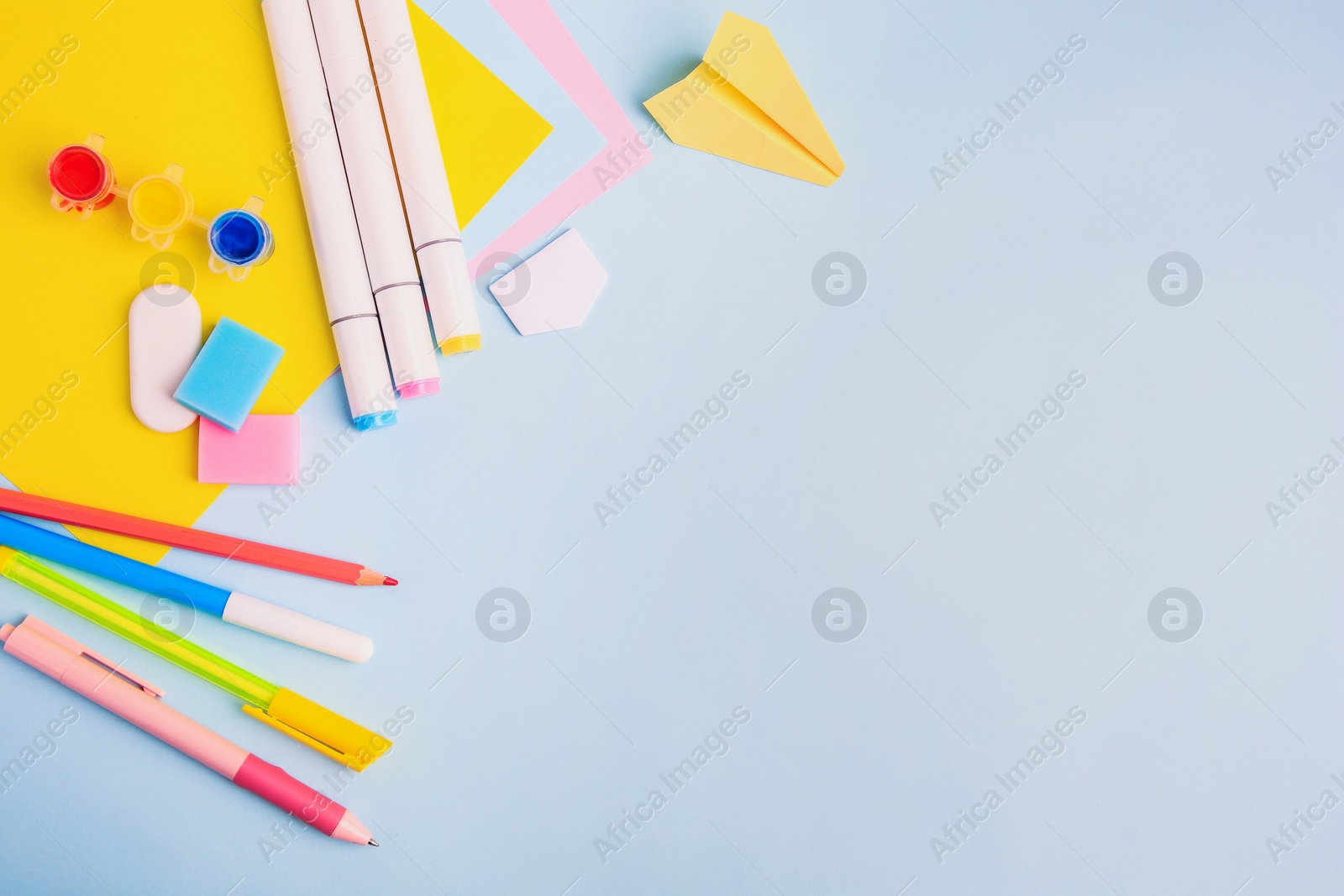 Photo of Flat lay composition with different school stationery on light blue background, space for text. Back to school