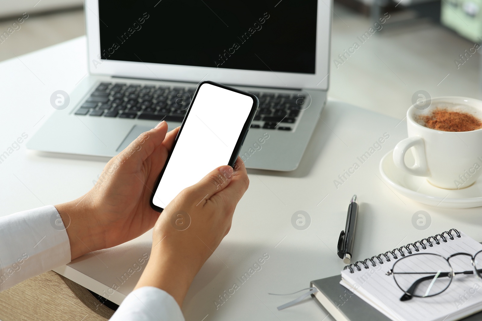 Photo of Woman using smartphone at table indoors, closeup