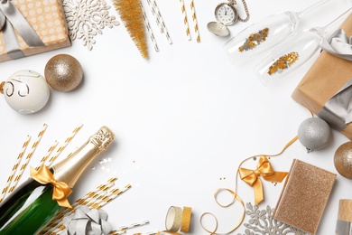 Creative flat lay composition with bottle of champagne and party accessories on white background. Space for text