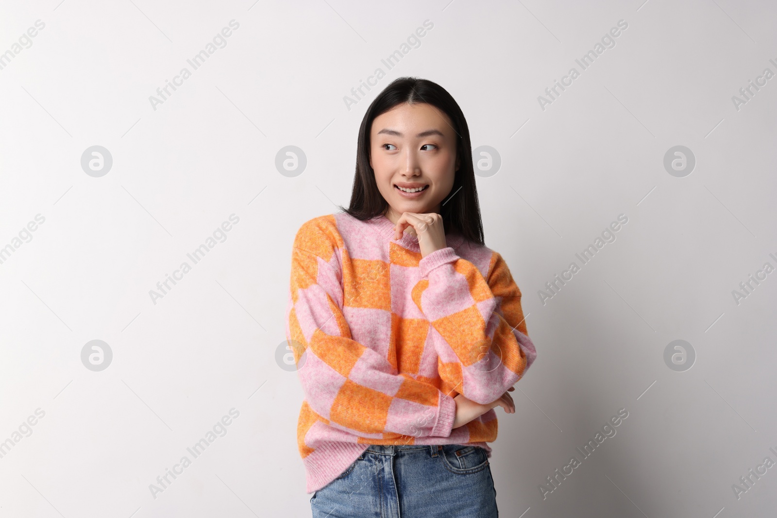 Photo of Portrait of smiling woman on light background