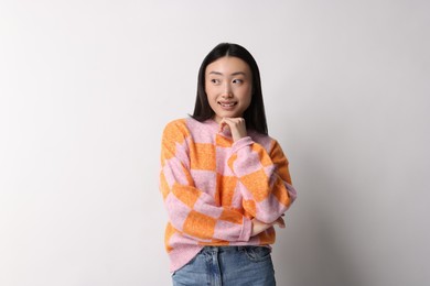 Photo of Portrait of smiling woman on light background