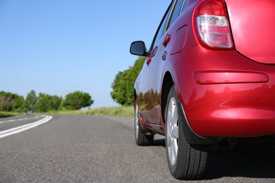 Modern color family car on highway, closeup. Space for text