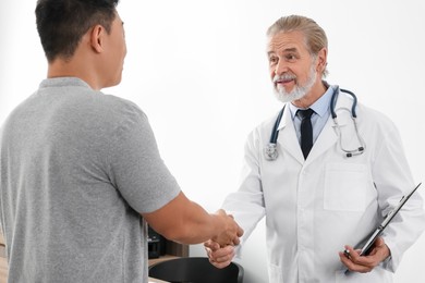 Photo of Doctor shaking hands with patient in hospital