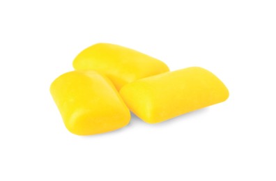 Photo of Tasty yellow chewing gums isolated on white