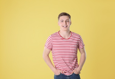 Photo of Portrait of teenage boy on yellow background