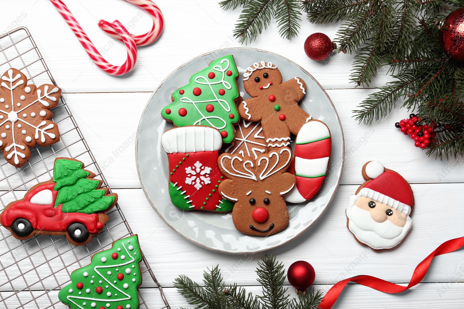 Photo of Tasty homemade Christmas cookies and decor on white wooden table, flat lay